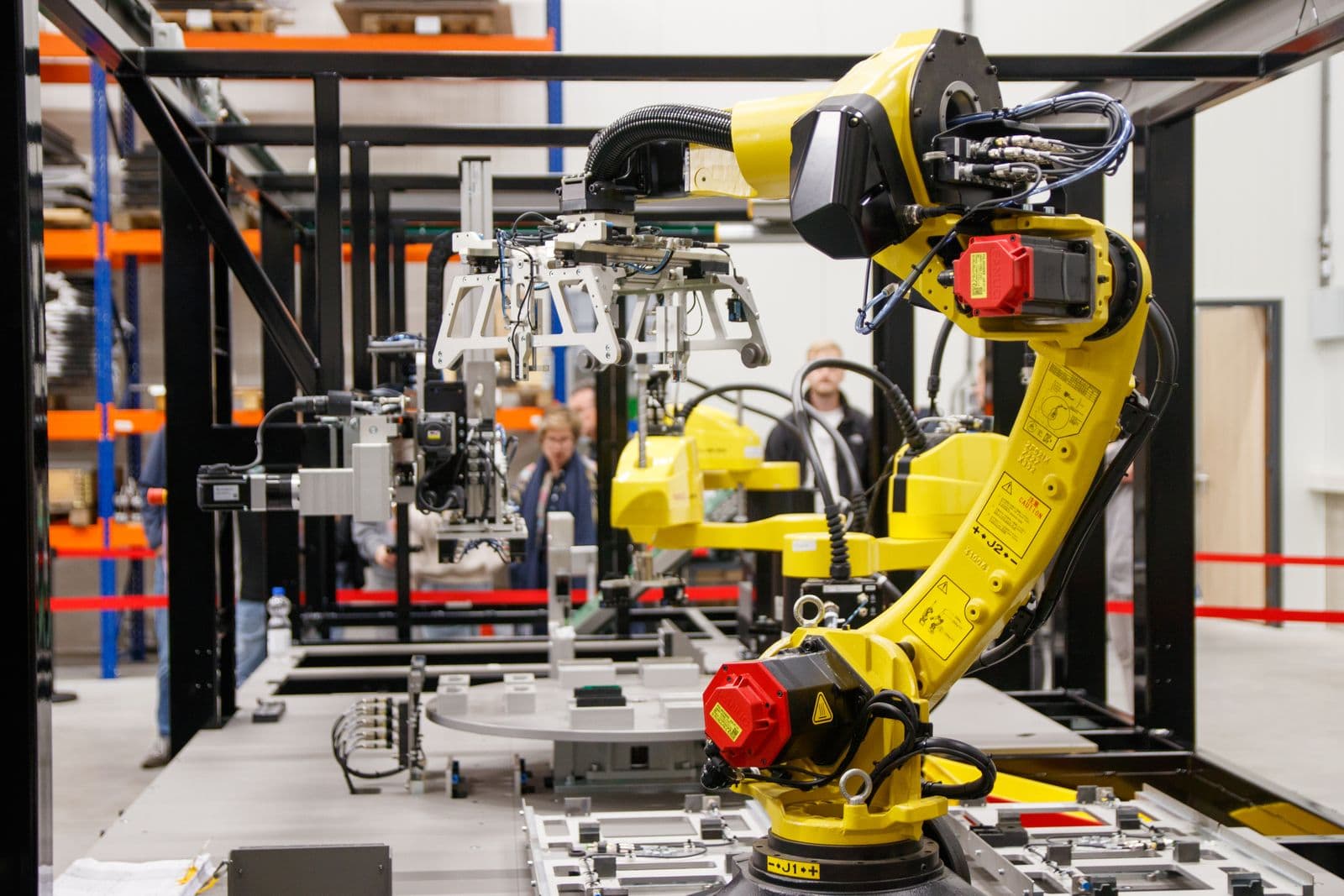 Industrial robotic arm operating on an automated manufacturing cell